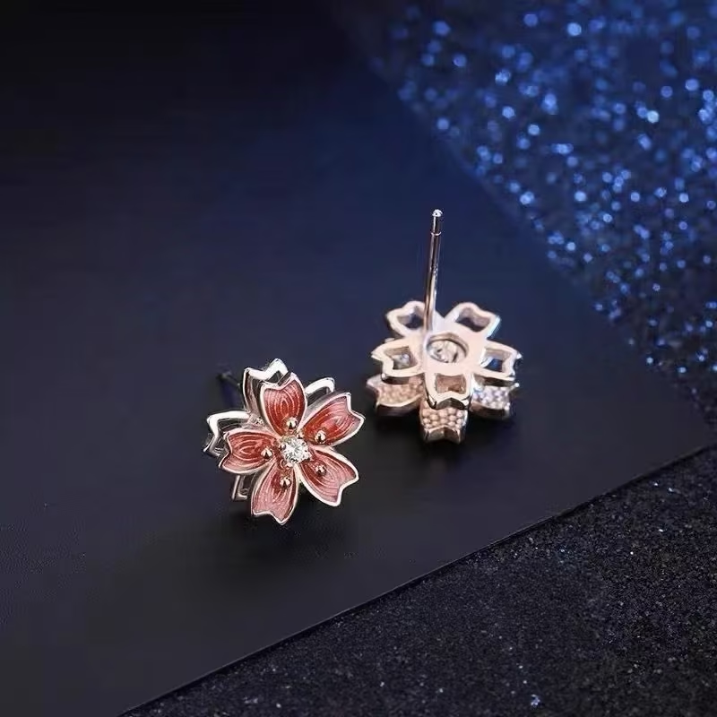Pendientes de tuerca giratorios de flor de durazno de plata de ley 925