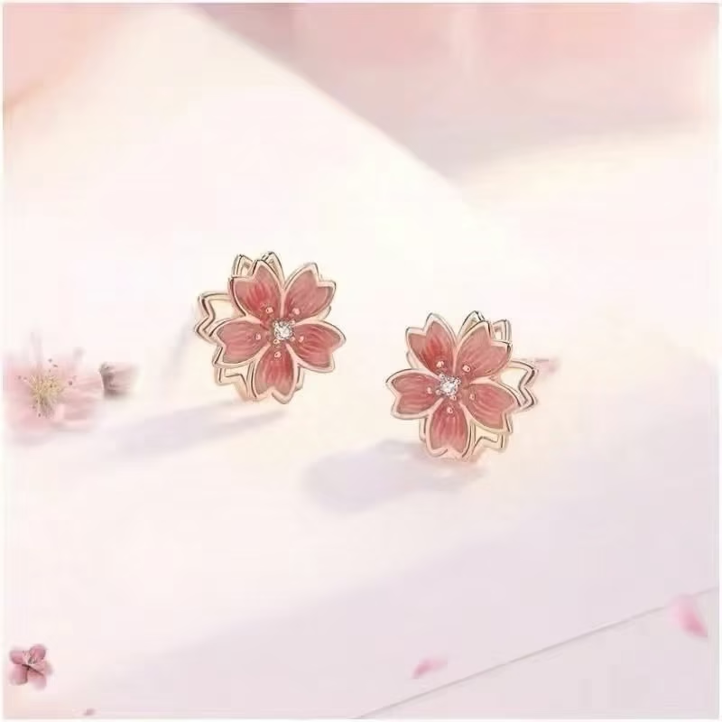 Pendientes de tuerca giratorios de flor de durazno de plata de ley 925