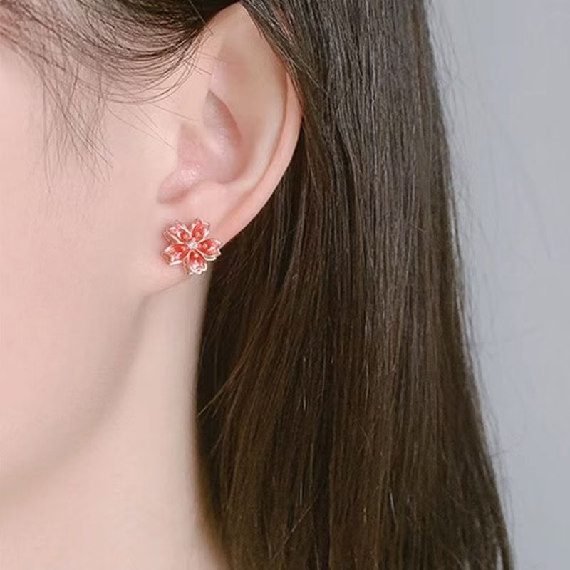 Pendientes de tuerca giratorios de flor de durazno de plata de ley 925
